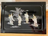 top view showing mother-of-pearl figures and artwork