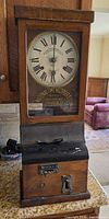 Full frontal view of the punch clock showing overall design and dial