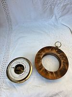 Barometer separated from wooden mount showing both pieces