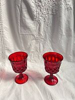Two red glass goblets front view showing color and pattern