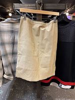 Front view of the tan BCBG skirt hanging