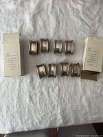 Eight napkin rings with two House of Fraser boxes