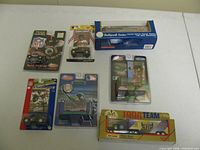 All seven sealed die-cast vehicles laid out on table