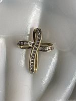 Front view of yellow gold twisted diamond cross pendant