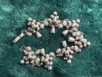 Bracelet arranged in circle showing grape cluster links and clasp