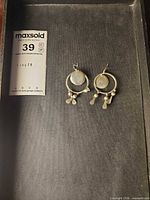 Front view of both sterling silver hoop earrings in tray