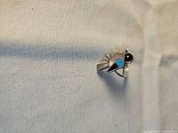 Front view of Zuni bird channel inlay ring