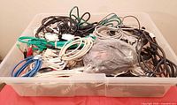 Overall bin filled with assorted coiled cables