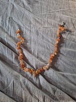 Full view of chip stone necklace showing clasp and extender
