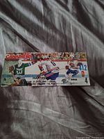 Front of ticket stub showing teams, date, seat and section
