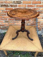 Full view of table showing top, turned column and tripod legs