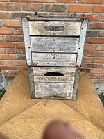 Front view of stacked Arthur Dairy and Milverton Dairy wooden milk crates
