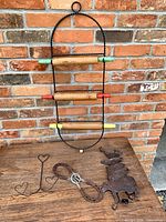 Overall lot showing rolling pin rack, horseshoe hanger, heart stand, silhouette plaque