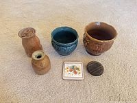Group view of two planters, two vases, two coasters