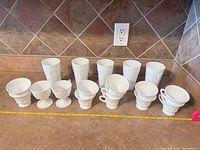 All 15 milk glass pieces lined on countertop
