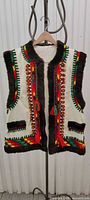 Front view of cream vest with colorful trim and brown faux fur