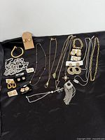 Entire assortment of necklaces, bracelets and earrings on black background