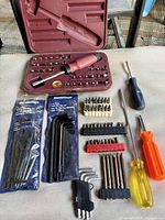 Overall lot layout showing case, screwdrivers, bit strips, hex key sets