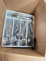 Box with flatware tray showing forks, spoons, knives, serving spoon