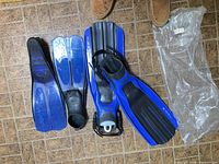 Two pairs of blue fins: TUSA Imprex adjustable strap pair and shorter full-foot pair