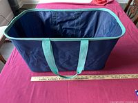 Tote standing open showing interior, handles, rim trim, ruler for scale