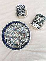 large floral ceramic bowl with two matching mugs
