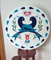 Full view of round Jacob Zook hex sign plaque on stand