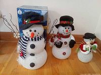 All three lighted snowmen with original box visible
