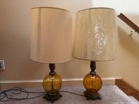 Pair of lamps with shades showing overall form and design