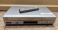 Front view of Sony SLV-N750 VCR with remote on top