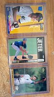 Three Derek Jeter rookie cards in plastic cases