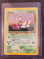 Front view of Yanma holo card in sleeve showing artwork, card number, attacks, and holographic foil