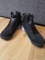 Oblique front view of both sneakers showing toe boxes, laces, tongues, midsoles.