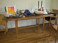 Overall view of dining table with leaves and tabletop pad