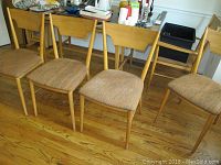 Five chairs in a row — four side chairs and one captain’s chair, front view