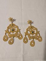 Full view of both gold plated chandelier earrings