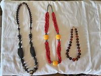 All three necklaces laid out showing overall design and relative sizes