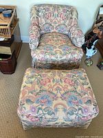 Front view of swivel armchair and ottoman showing upholstery pattern and overall condition