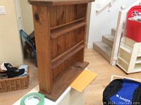 Wooden display shelf showing three horizontal ledges and natural wood finish