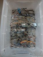 Top view of bin containing numerous eyeglasses pairs
