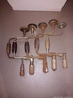 Group shot of five vintage hand braces showing overall condition and quantity