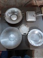 All five pewter pieces arranged together for scale and identification