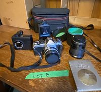Group shot showing Nikon camera with lens, zoom lens, flash, light meter, bag, manual