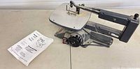 Full view of Craftsman scroll saw with manual on table