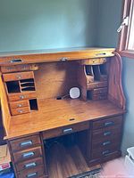 Desk open showing interior cubbies, small drawers, kneehole