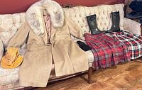 Full lot on sofa: coat, fur collar, hat, gloves, scarves, boots