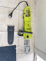 Full view of Sun Joe chainsaw with power cord and bar cover