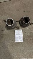 Top view of two aluminum hose adapters showing overall condition
