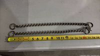 Both choke chains laid flat beside tape measure showing 16 in length