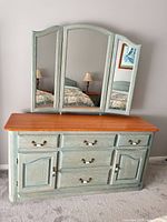 Full view of dresser with attached mirror showing color, hardware, and design